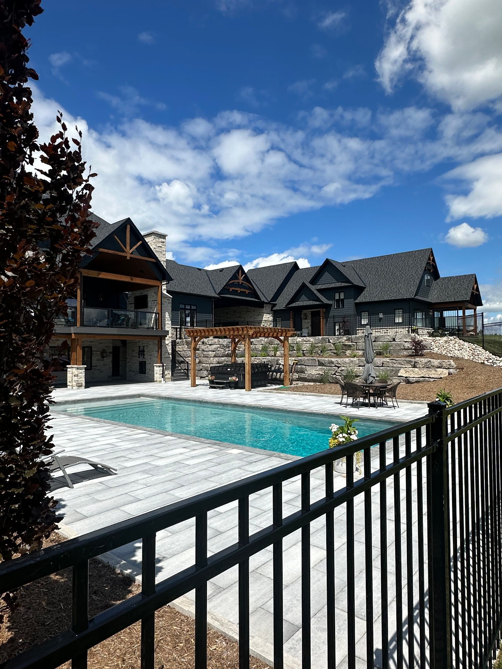 A large house with a swimming pool in front of it