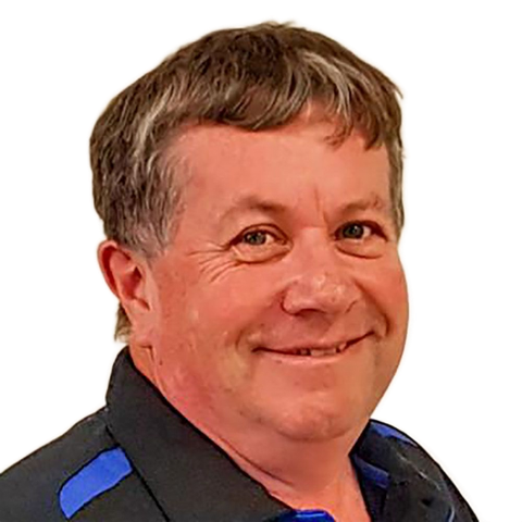 Smiling man in a black shirt with blue accents against a white background