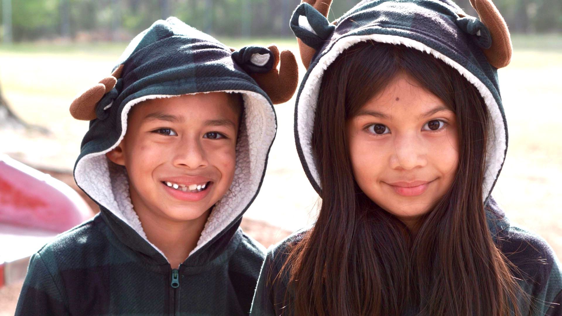 two children in bear hooded sweatshirts