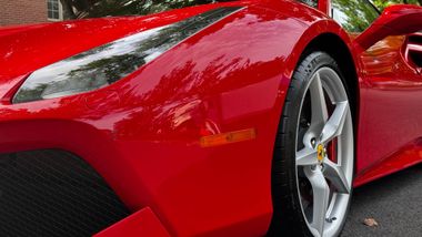 Polished vehicle exterior in residential setting