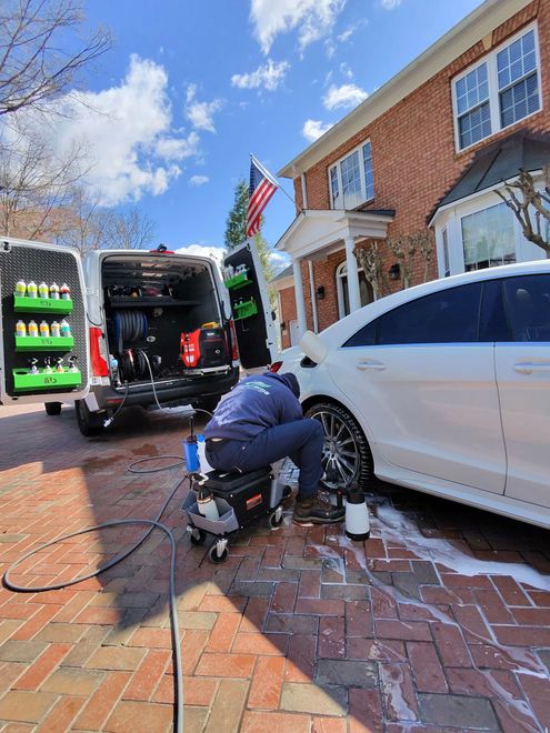 Detailer finishing a vehicle door panel