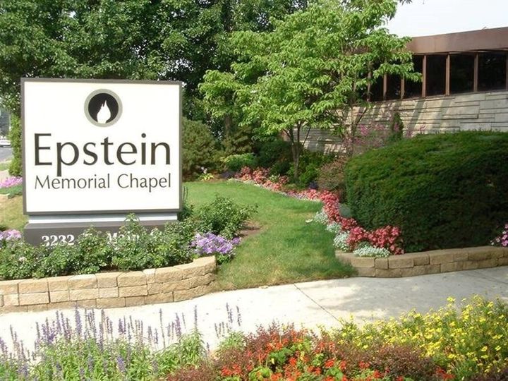 Epstein Memorial Chapel sign beside landscaped greenery and flowers