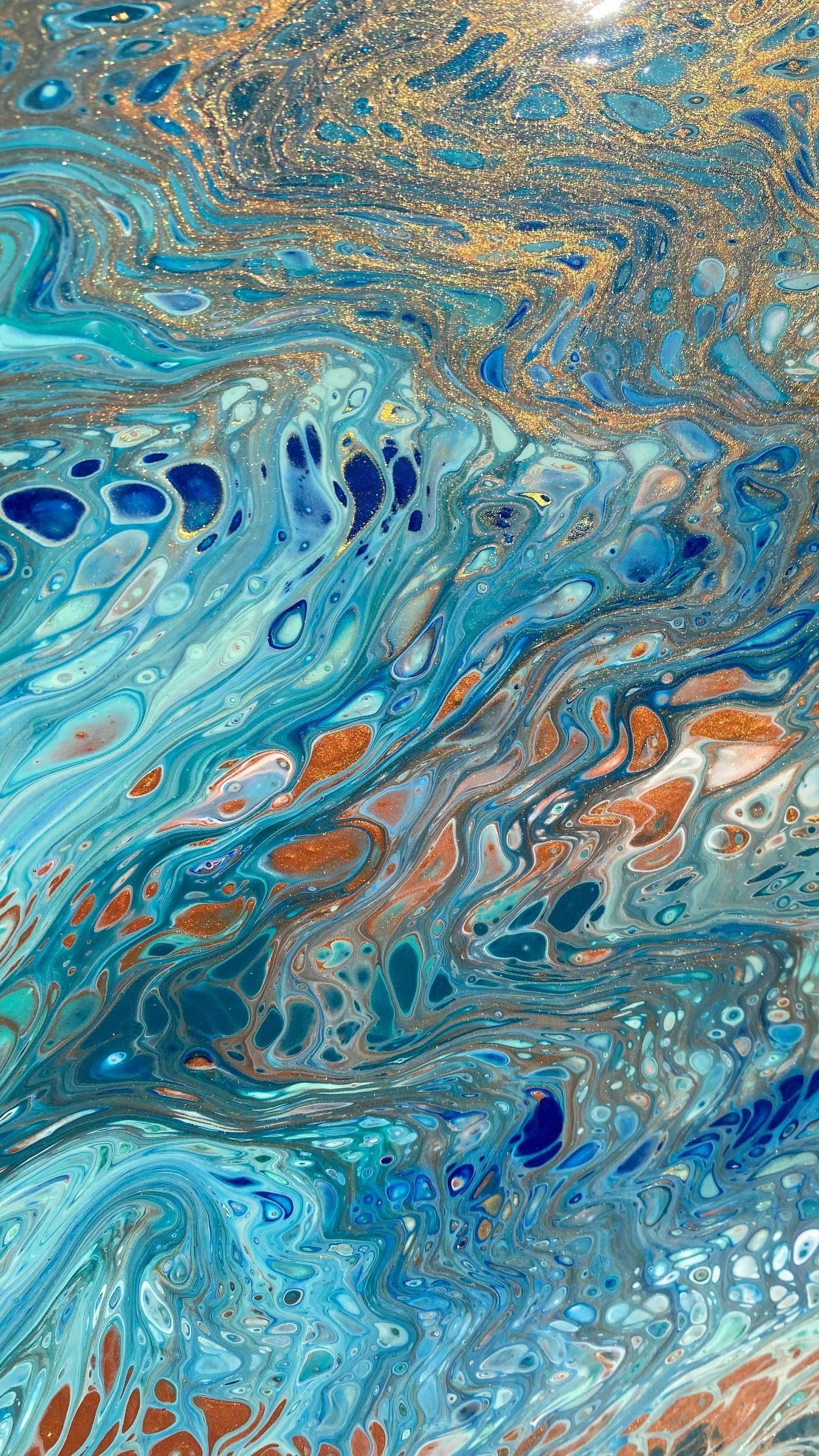Teal and copper poured acrylic breaking into lacework cells