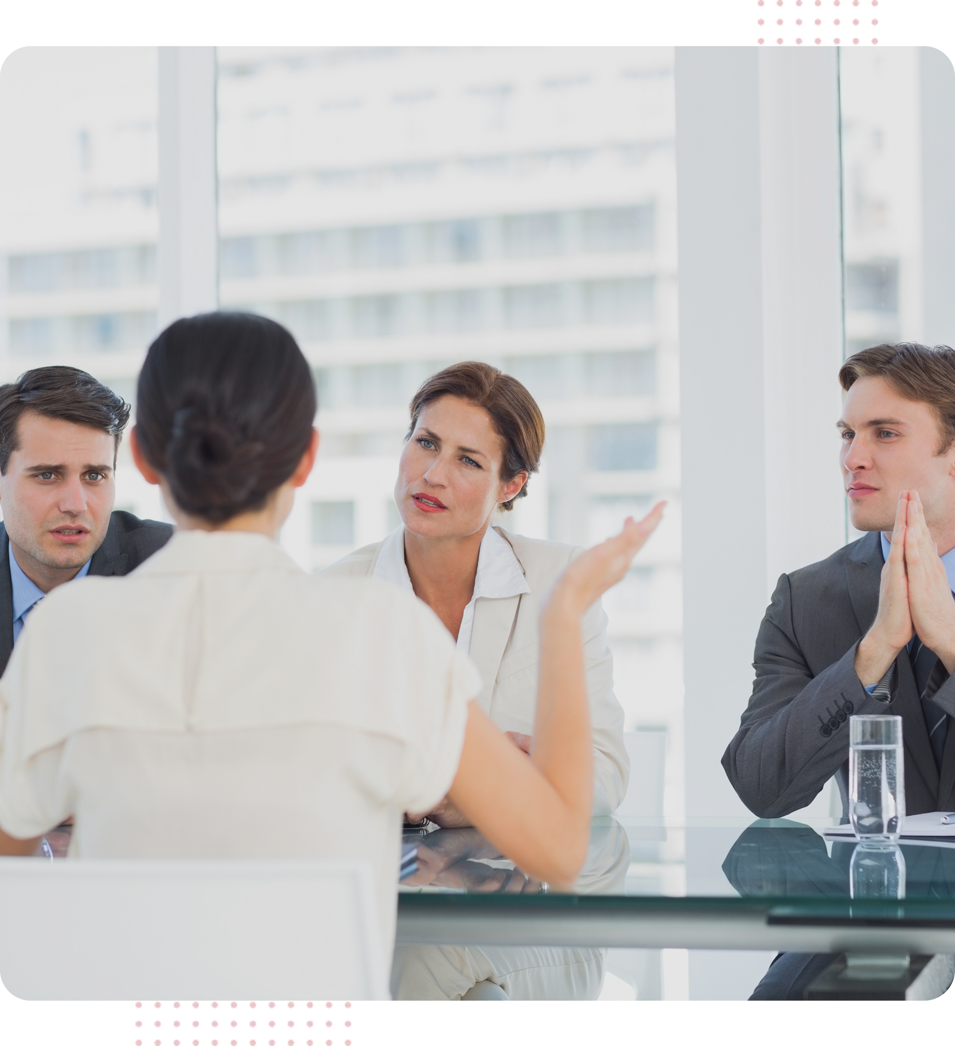 A group of people are sitting around a table having a conversation