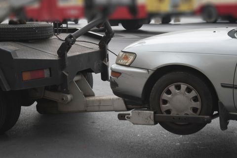 A trailer is being towed by a truck on a road. A trailer is being towed by a truck on a road.