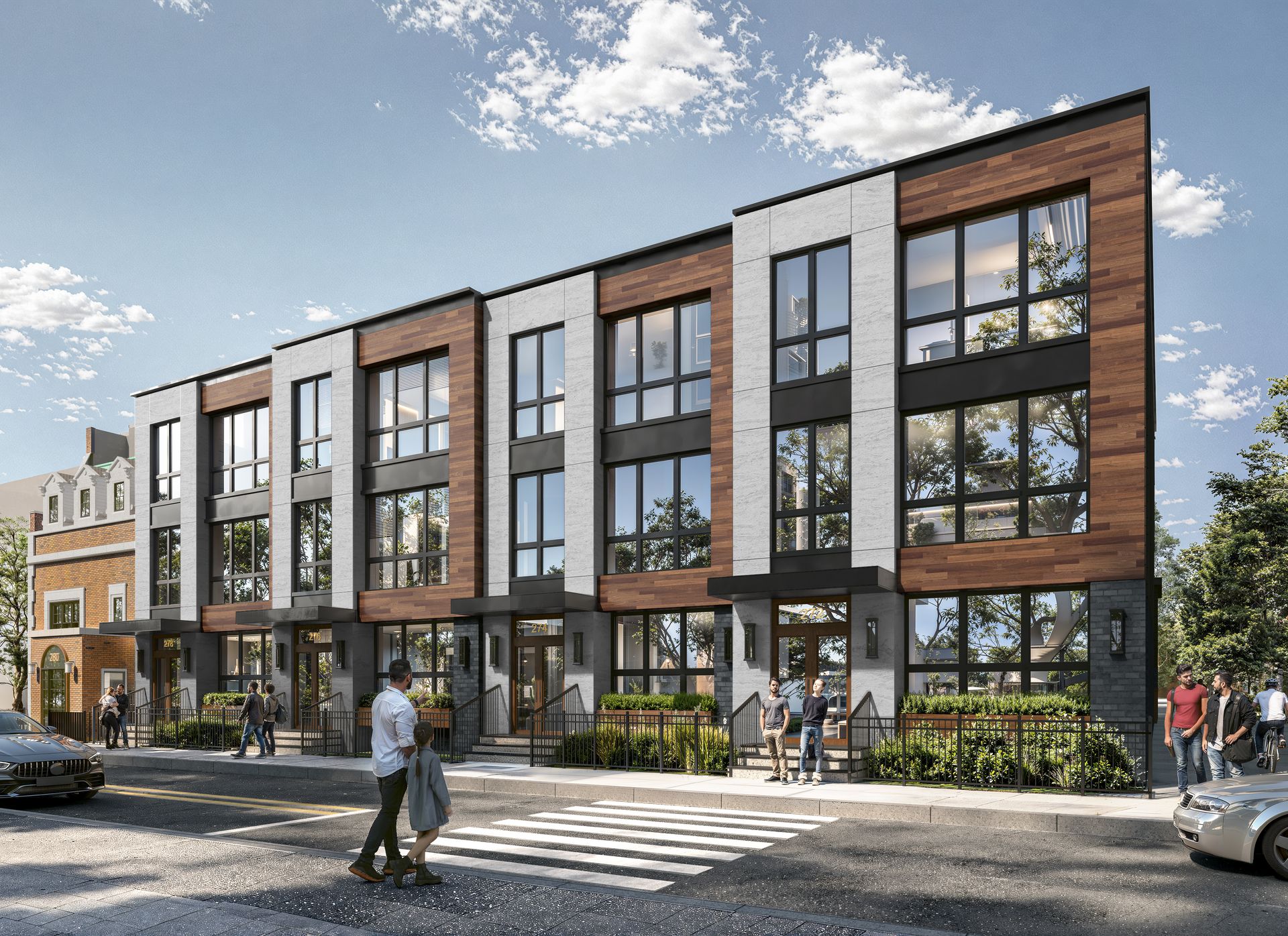 Modern townhouses with brick and white accents, people crossing the street.