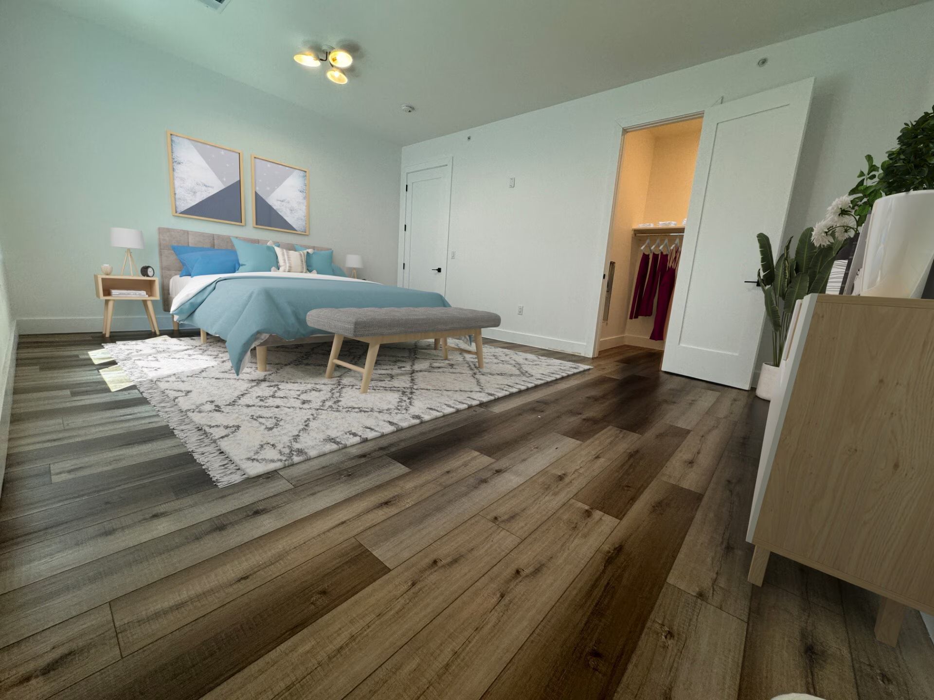 Bedroom with bed, closet, and light wood floors. Blue and white decor.