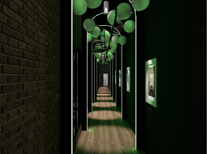 Dark, long hallway with green lighting, artwork, and ceiling decorations; brick wall on the left.