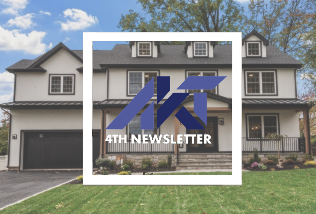 Modern white house with dark garage door, and a blue and white logo: 