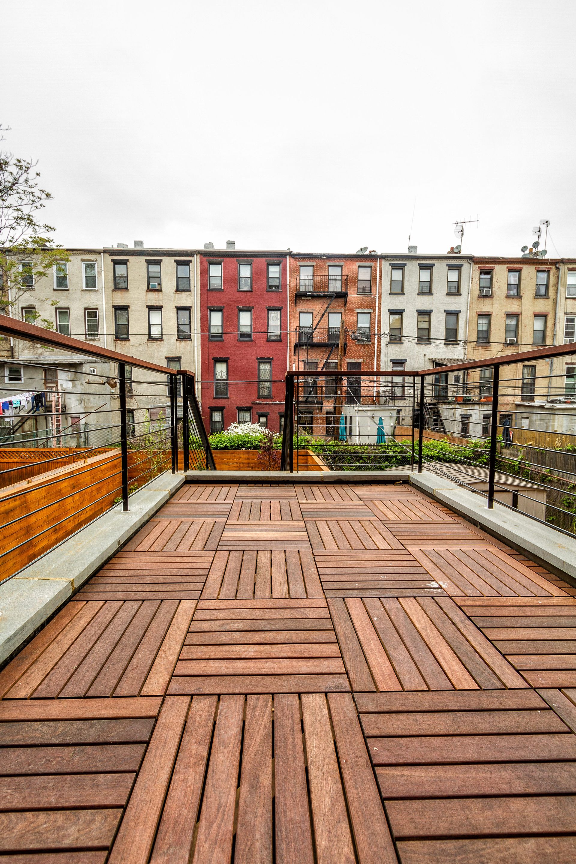Wooden deck with a view of colorful buildings.