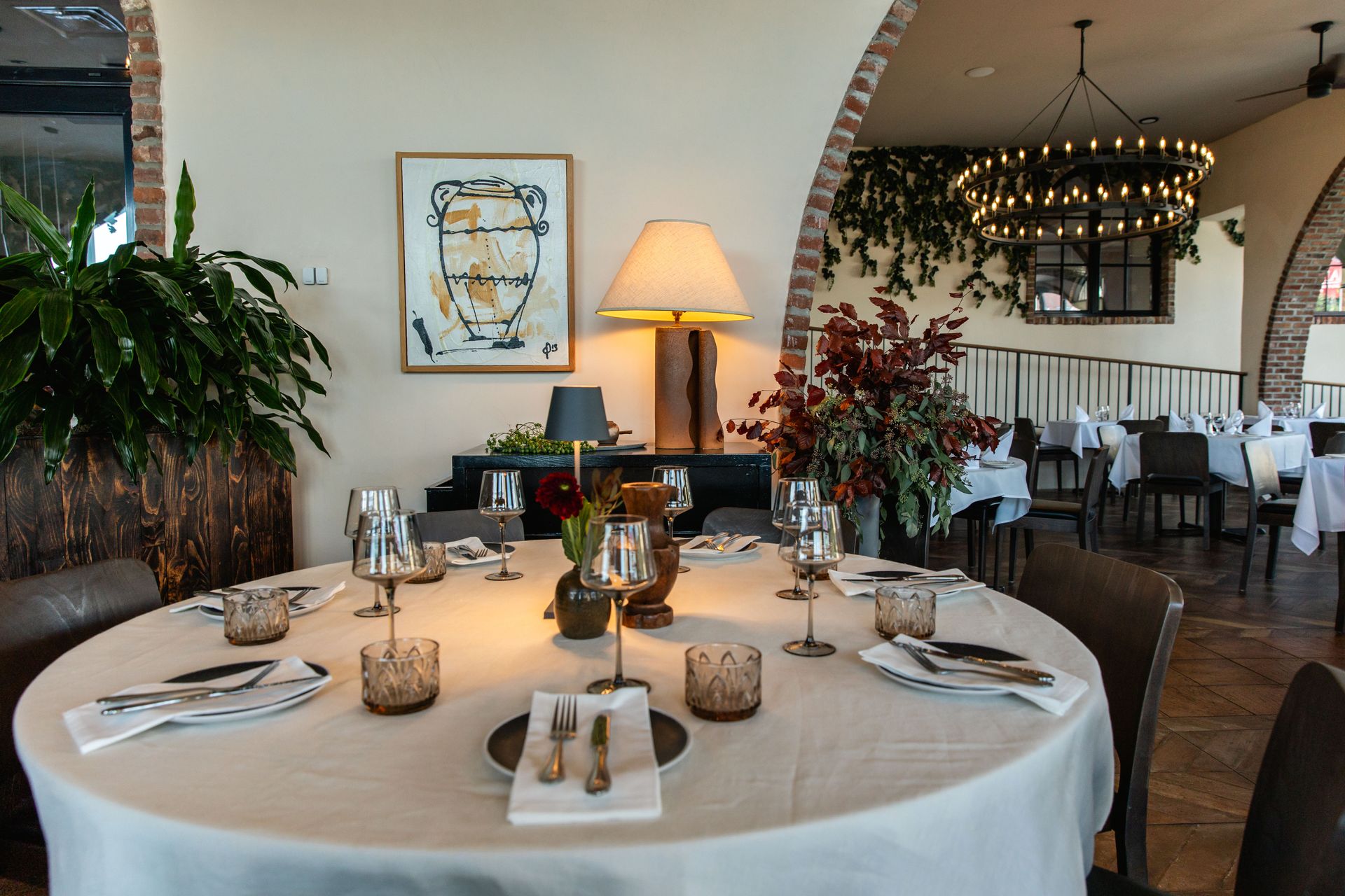 Elegant restaurant table set for a meal, with a white tablecloth and glassware.