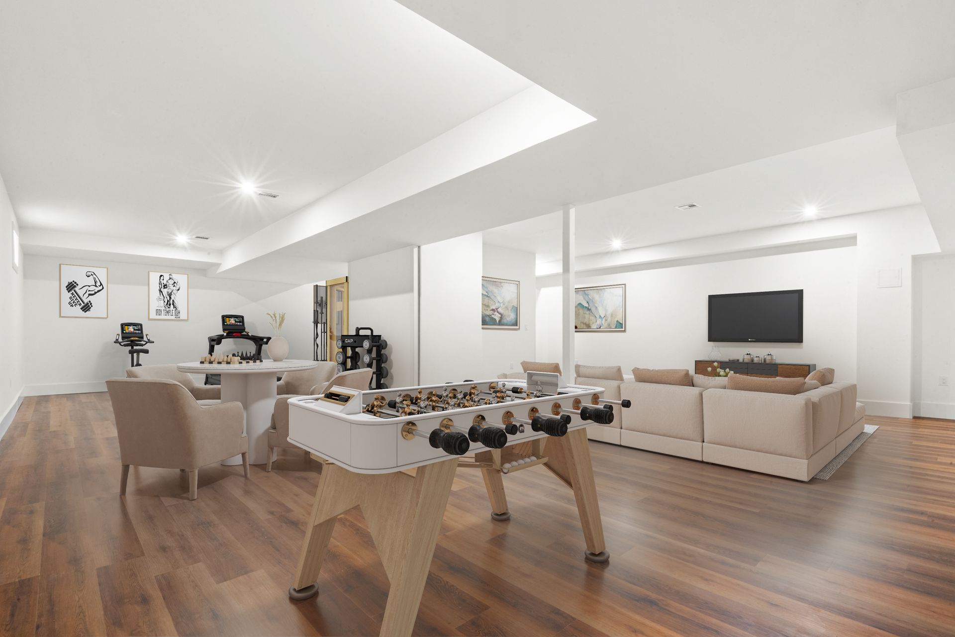Spacious finished basement with foosball table, seating area, and wall-mounted TV; hardwood floors.