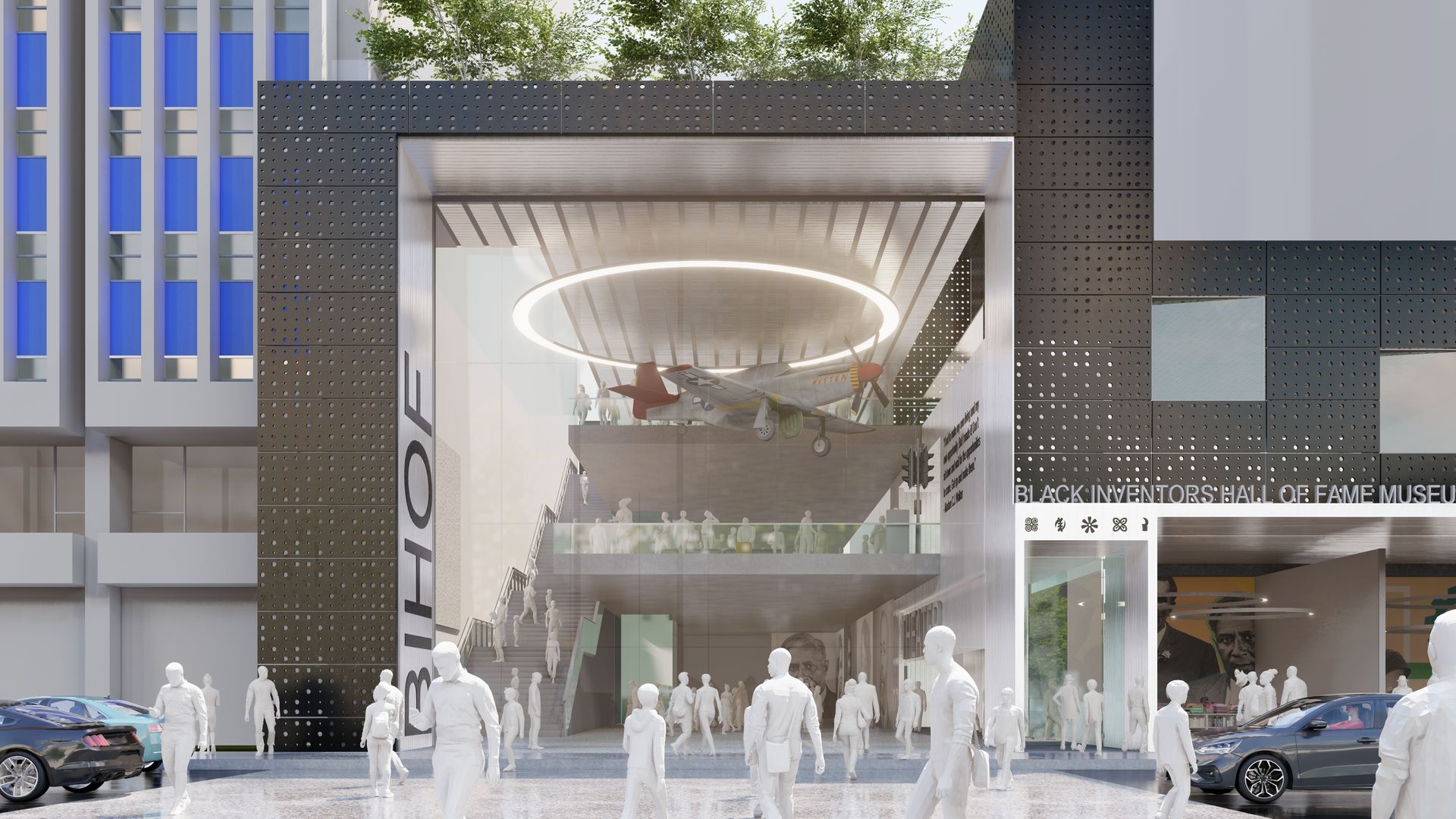 Modern building entrance with a glass facade, people in front, and a circular light fixture inside.