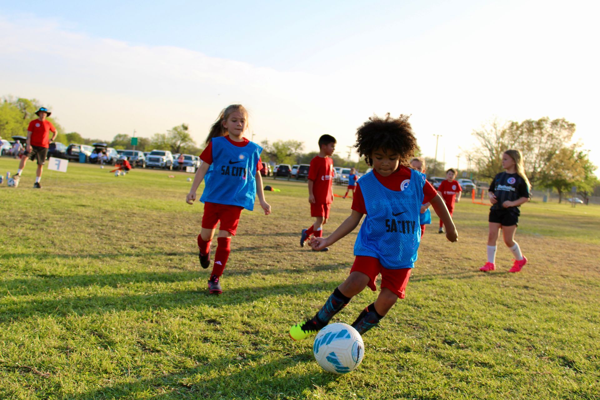 A group of young girls playing soccer for San Antonio City Soccer Club