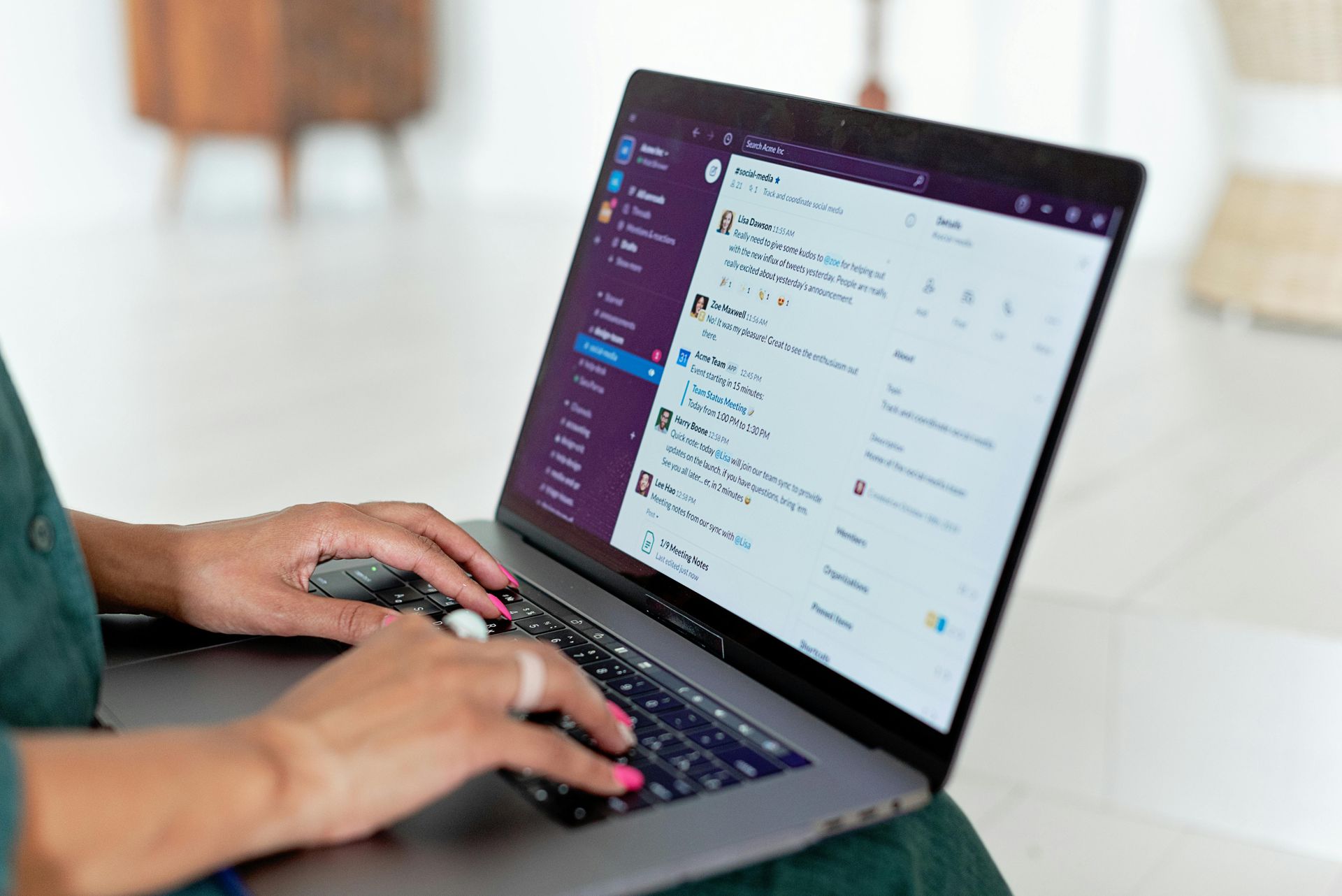 A woman is typing on a laptop computer.