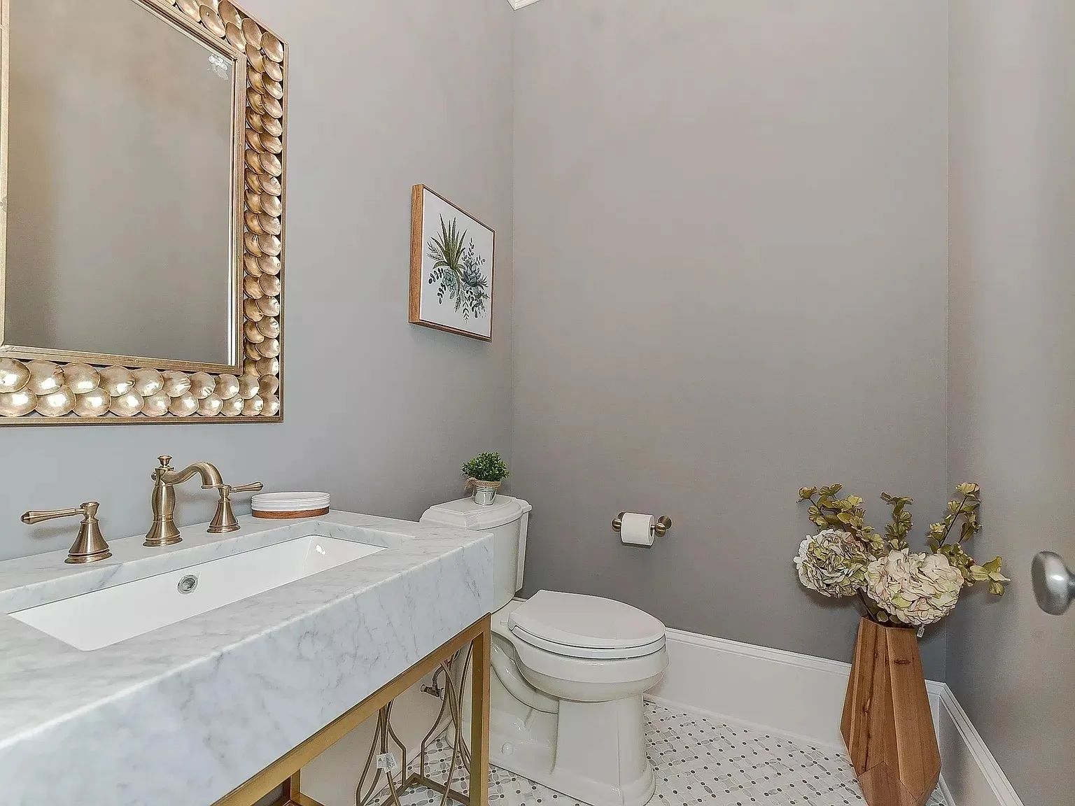 A bathroom with a sink , toilet , mirror and bathtub.