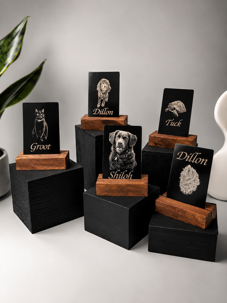 Four black-and-wood decorative name plaques on display stands against a light background.
