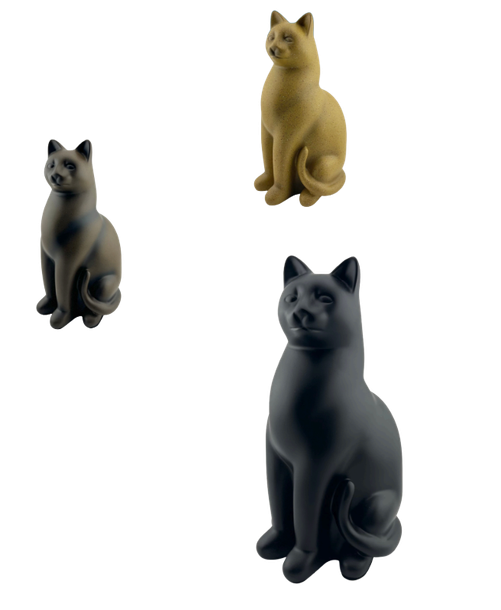 Three sitting cat figurines in black, gold, and black on a white background