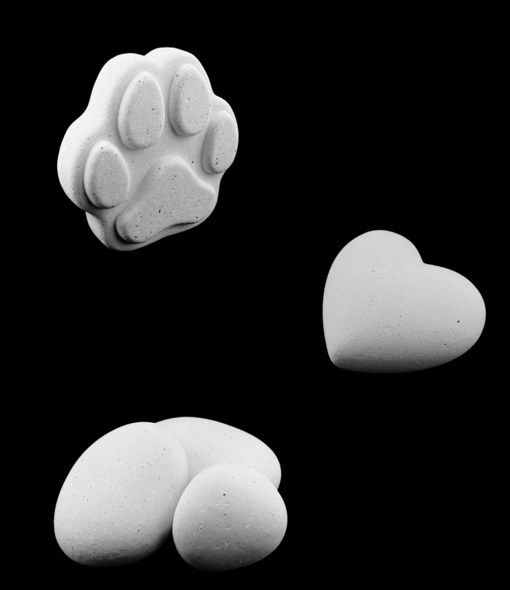 Three white sculpted paw-print shapes on a black background, one heart-shaped and two rounded forms.