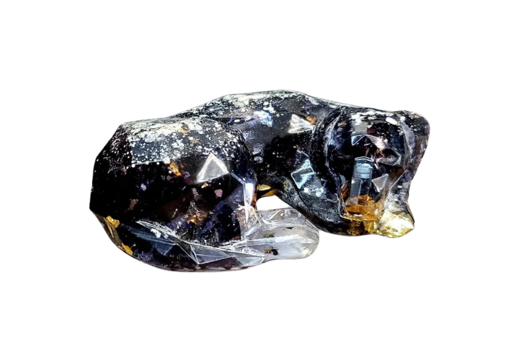 Dark, glossy black mineral rock with sharp facets on a white background