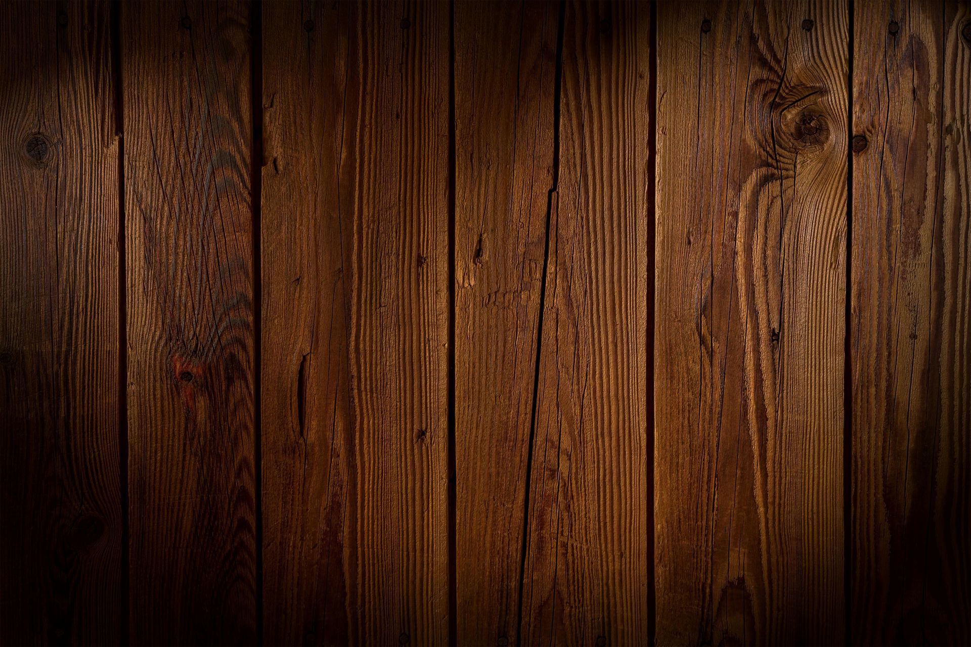 Dark brown wooden planks, vertical grain, rustic texture.