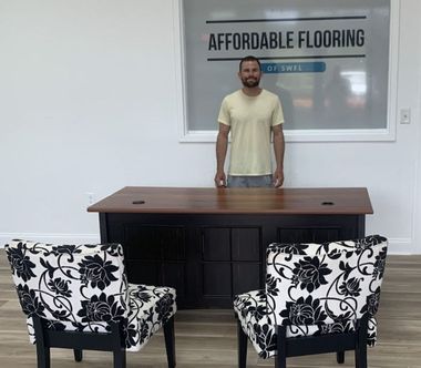 A man standing in front of a desk that says affordable flooring
