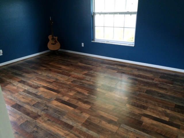 There is a guitar in the corner of the room.
