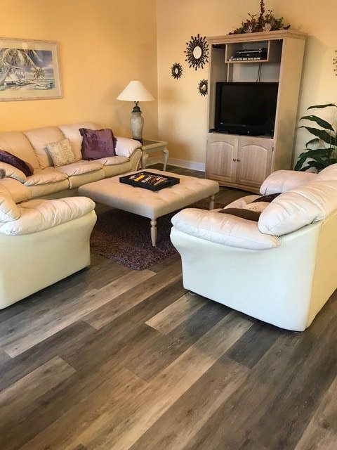A living room with a couch and two chairs