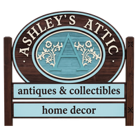 Ashley’s Attic sign with teal accents, reading “antiques & collectibles” and “home decor”