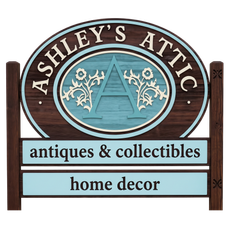 Ashley’s Attic sign with teal accents, reading “antiques & collectibles” and “home decor”