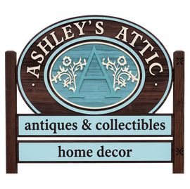 Ashley’s Attic sign with antiques & collectibles and home decor on a wood background