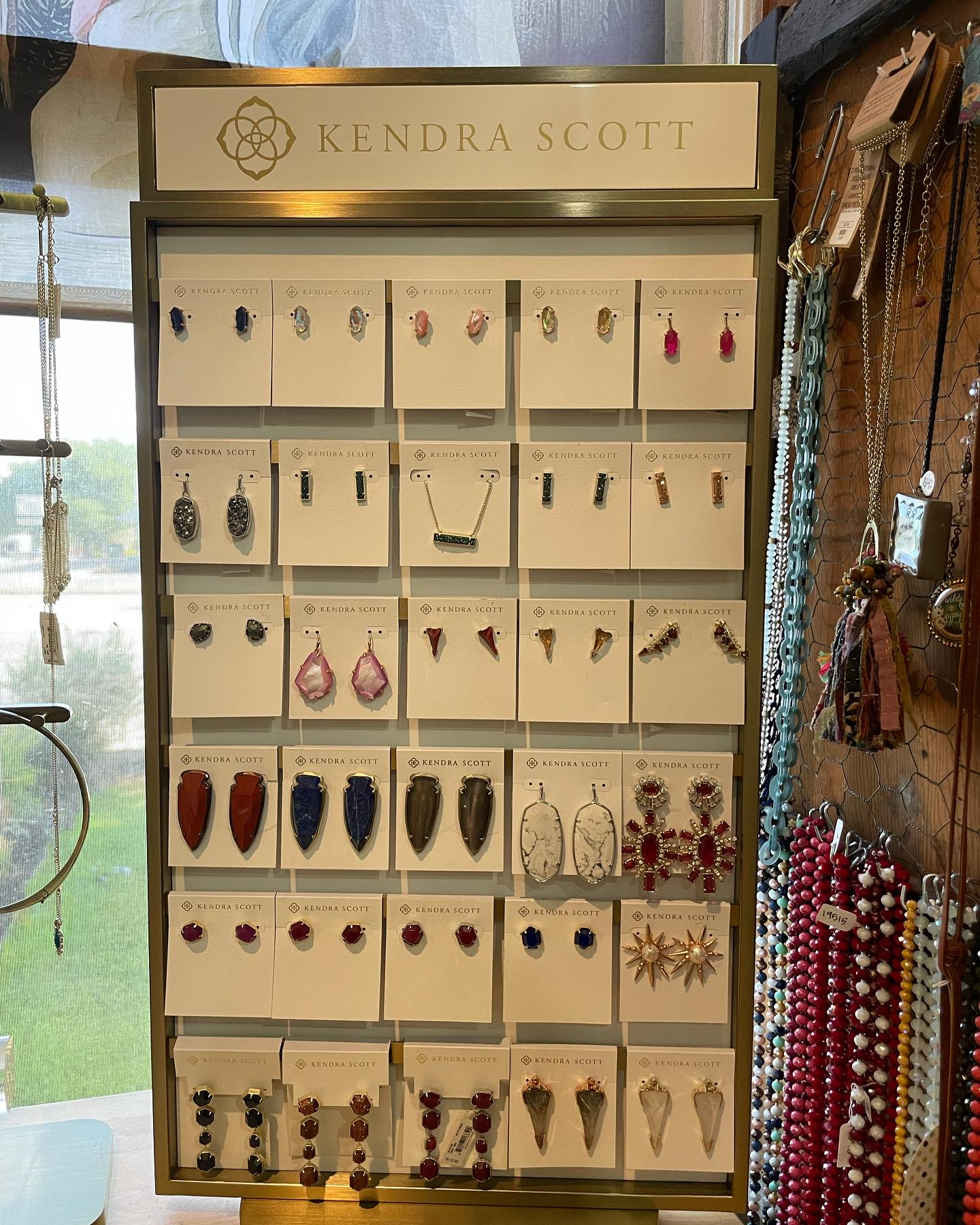 Jewelry display case with assorted earrings and necklaces in a boutique