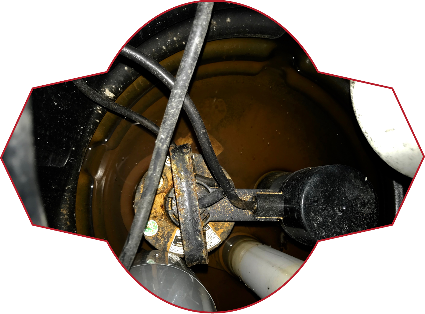 A close up of a drain with a few wires coming out of it