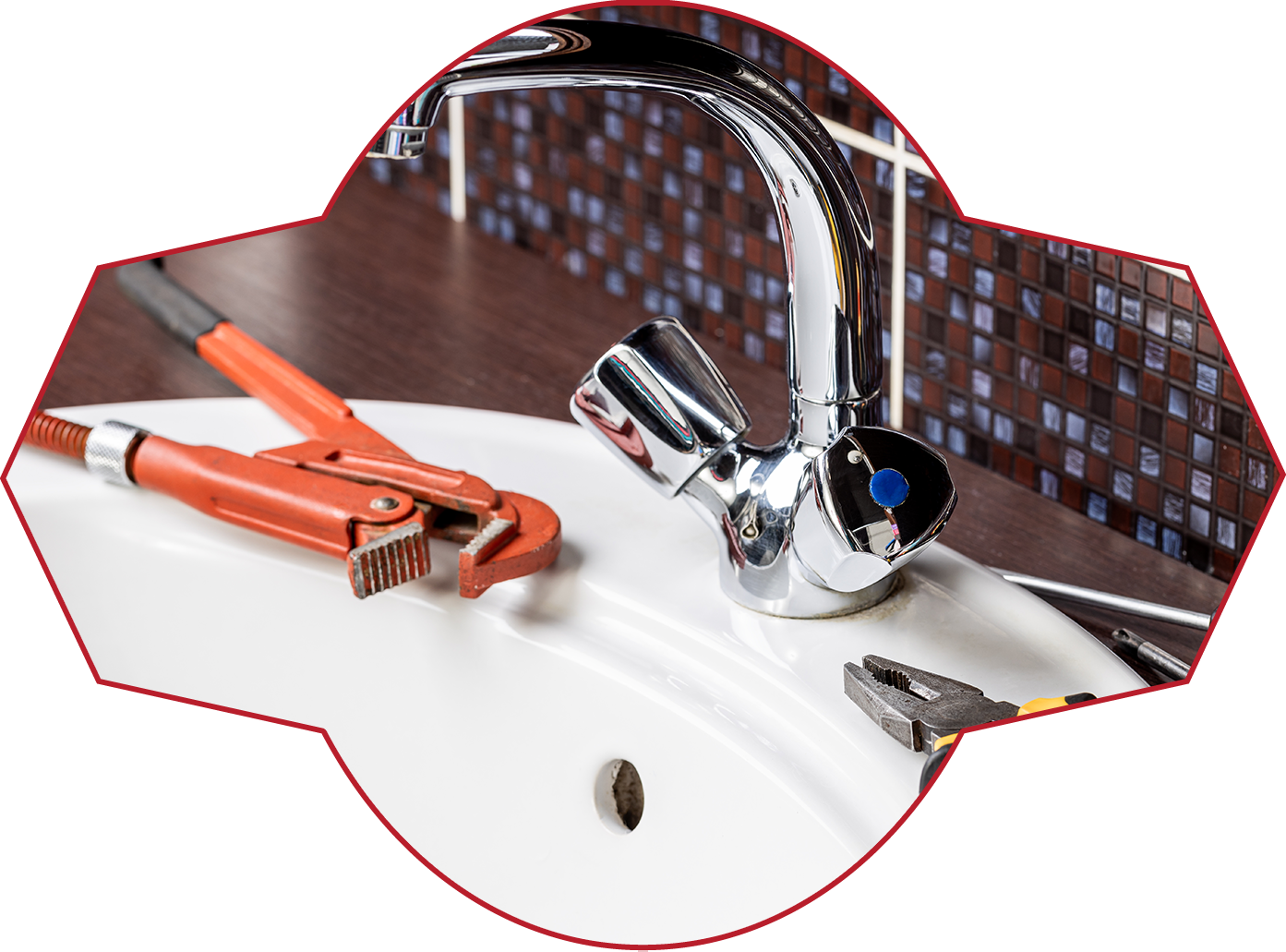 A Sink With a Faucet and a Wrench on It