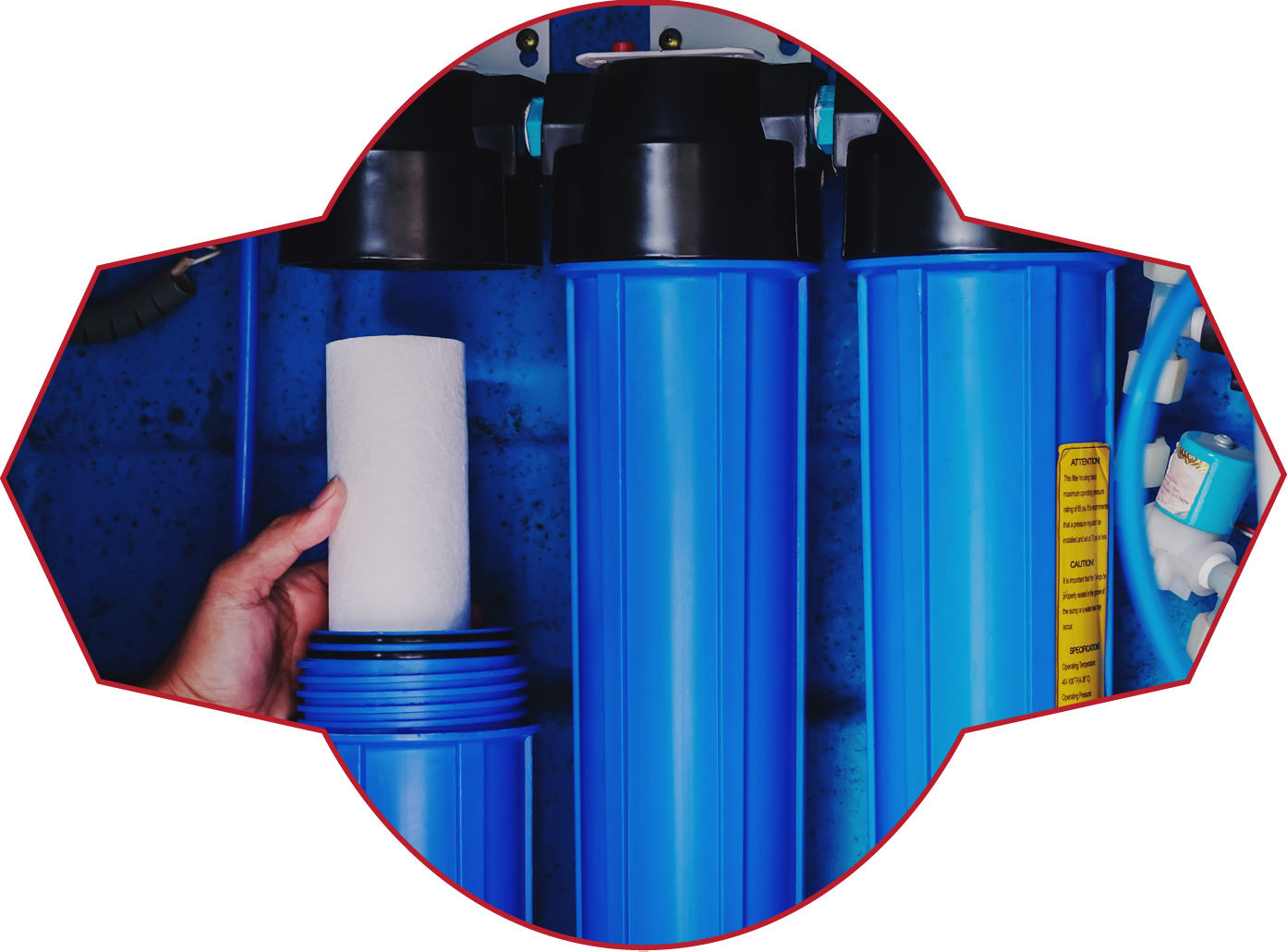 A person is putting a filter into a blue water filter