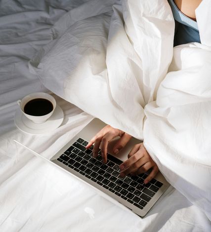 Guest relaxing with a laptop and coffee in a Copenhagen short-term rental apartment