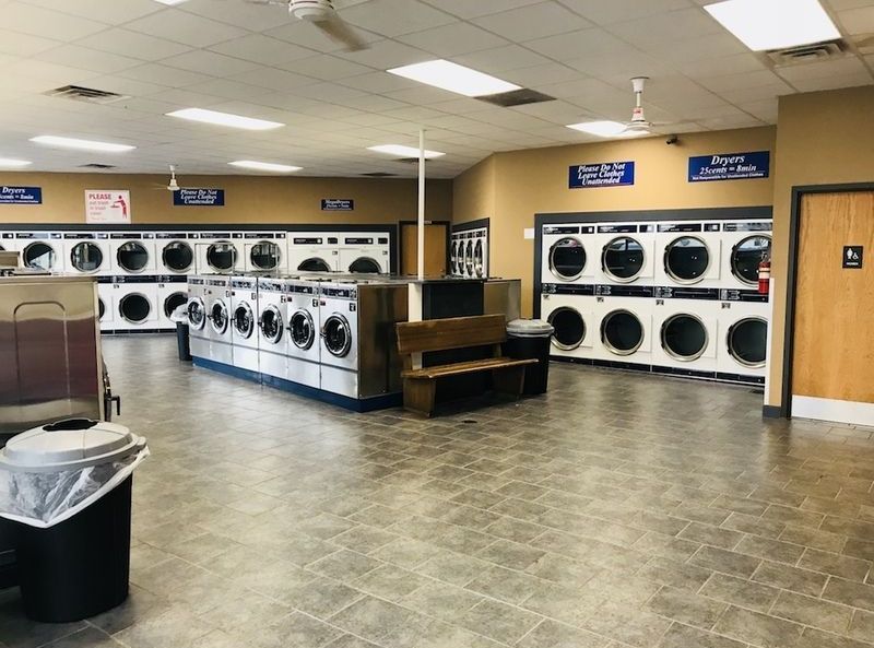 A laundromat with a lot of washers and dryers