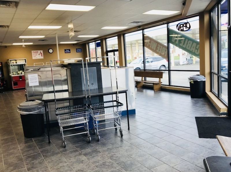 A laundromat with a sign that says ' lions ' on it