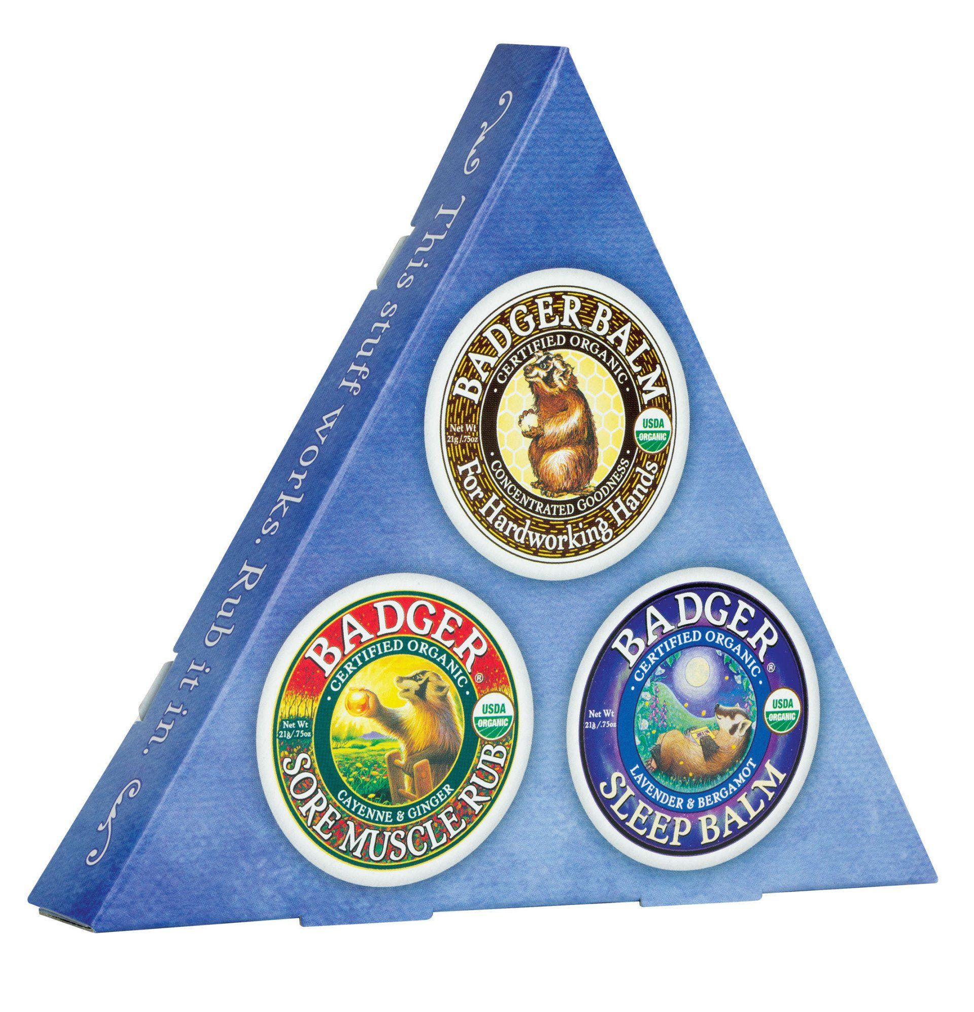 Triangular box of Badger Balm containing three round tins: classic, sore muscle rub, and sleep balm.