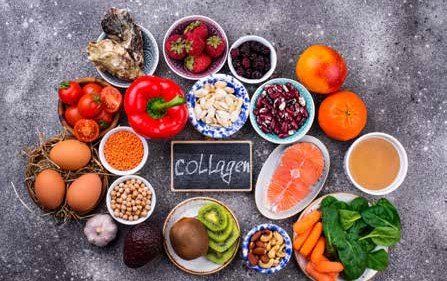 Various foods arranged around a chalkboard that reads
