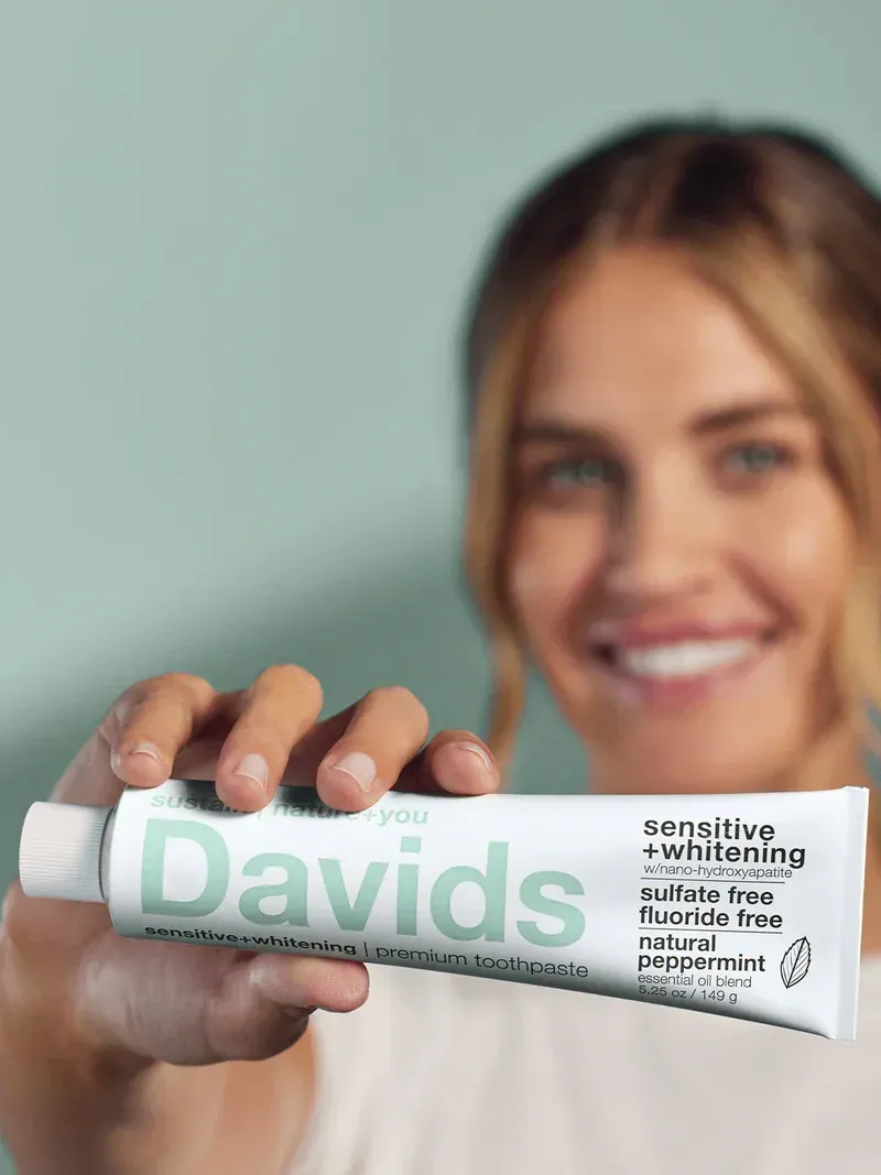 Woman holding up a tube of