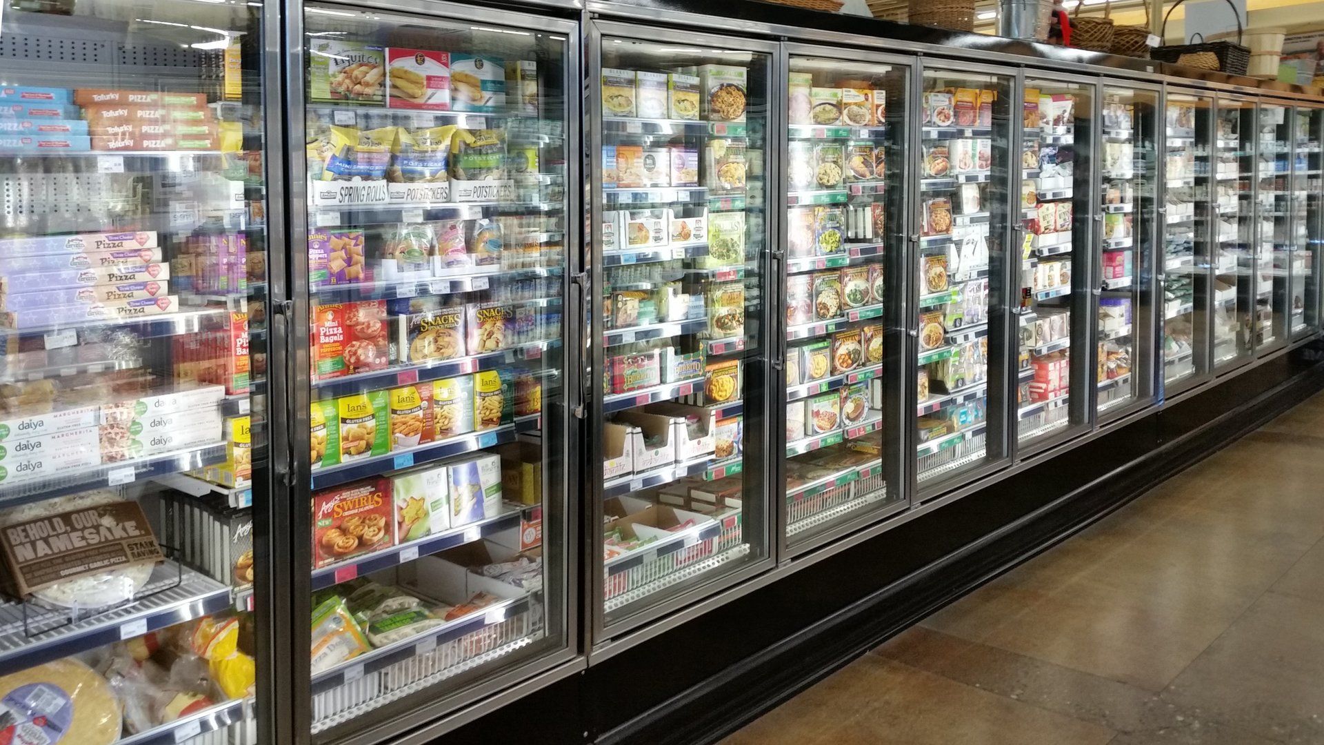 Freezer cases filled with frozen food at a grocery store.