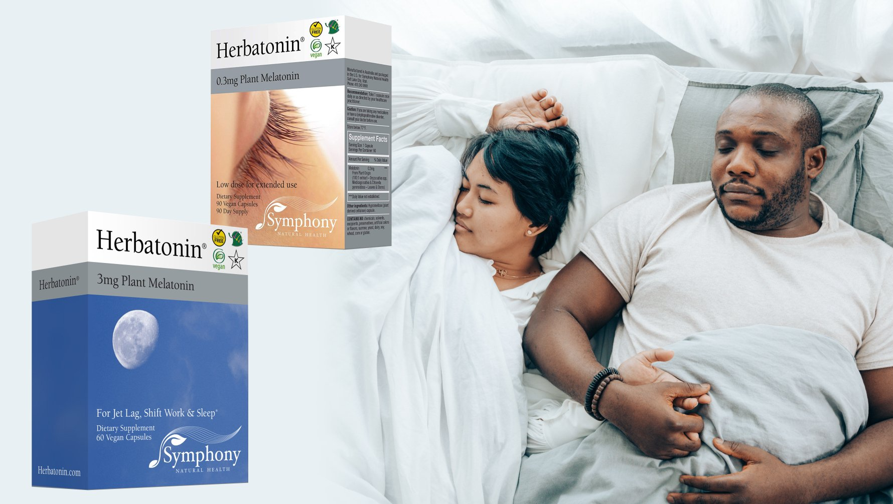 A couple lies in bed, one awake and holding the other's hand. Two boxes of