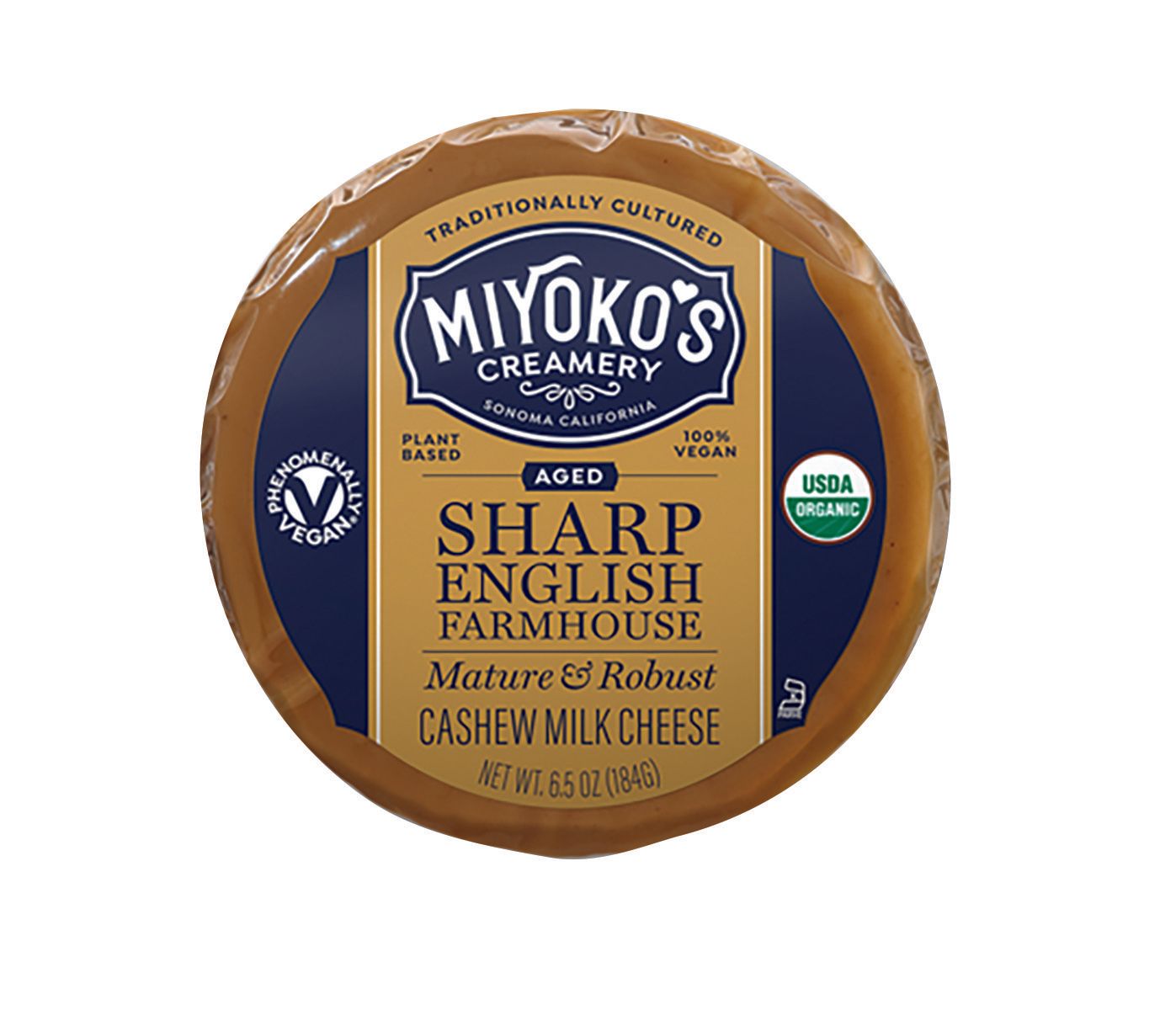 Aged Sharp English Farmhouse cashew milk cheese from Miyoko's Creamery. It is round, wrapped in paper, with blue and gold label.