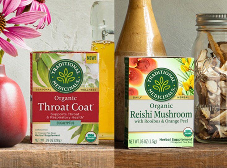 Two Traditional Medicinals tea boxes: Throat Coat (left) and Reishi Mushroom (right). Boxes are on a shelf with other decorative items.