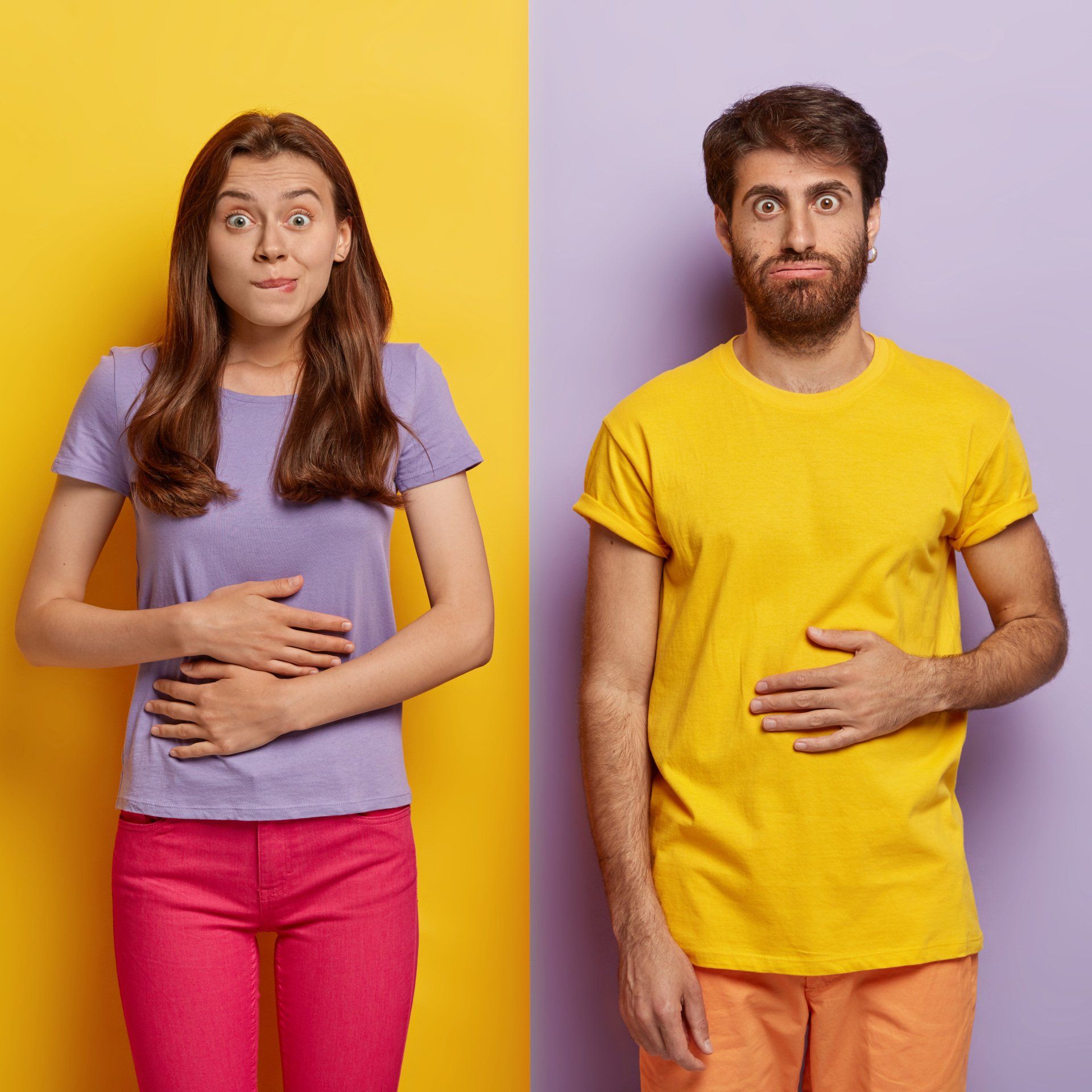 Woman and man with hands on their stomachs, looking concerned, in front of yellow and purple backgrounds.