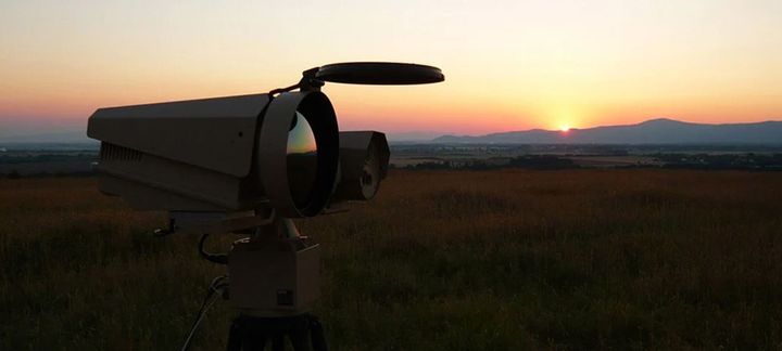 a camera setup in the desert at sunset