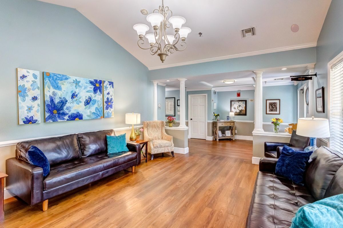 A living room filled with furniture and a chandelier.