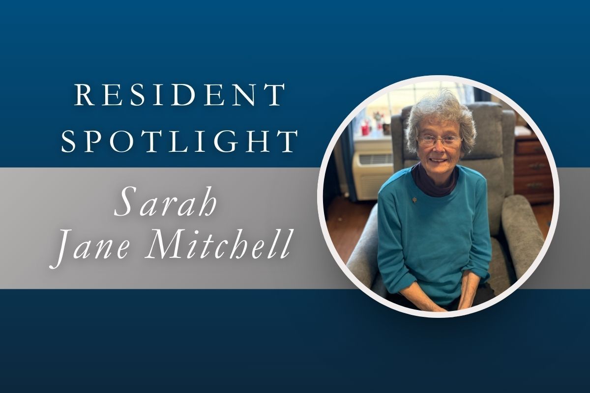 Resident spotlight graphic: Sarah Jane Mitchell sits smiling in a chair; text overlay on a blue and gray background.