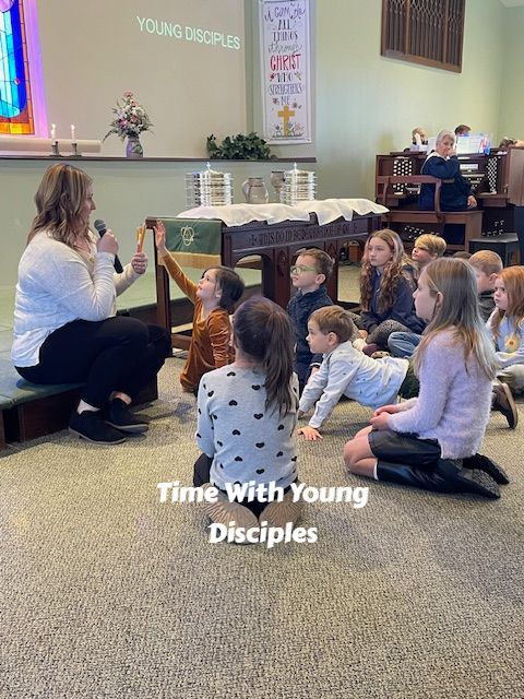 Instructor reading to children seated on carpet in a church sanctuary, with “Time With Young Disciples” text on screen